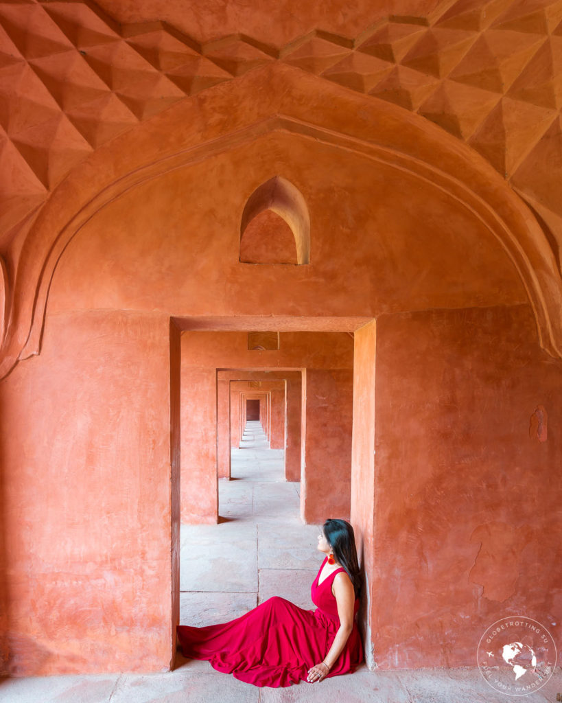 Girl sitting and providing the perfect symmetry for Taj-Mahal-Building
