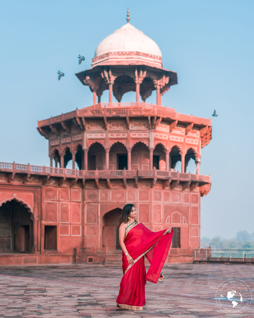 Girl wearing red Saree and posing in the Taj-Mahal-Complex
