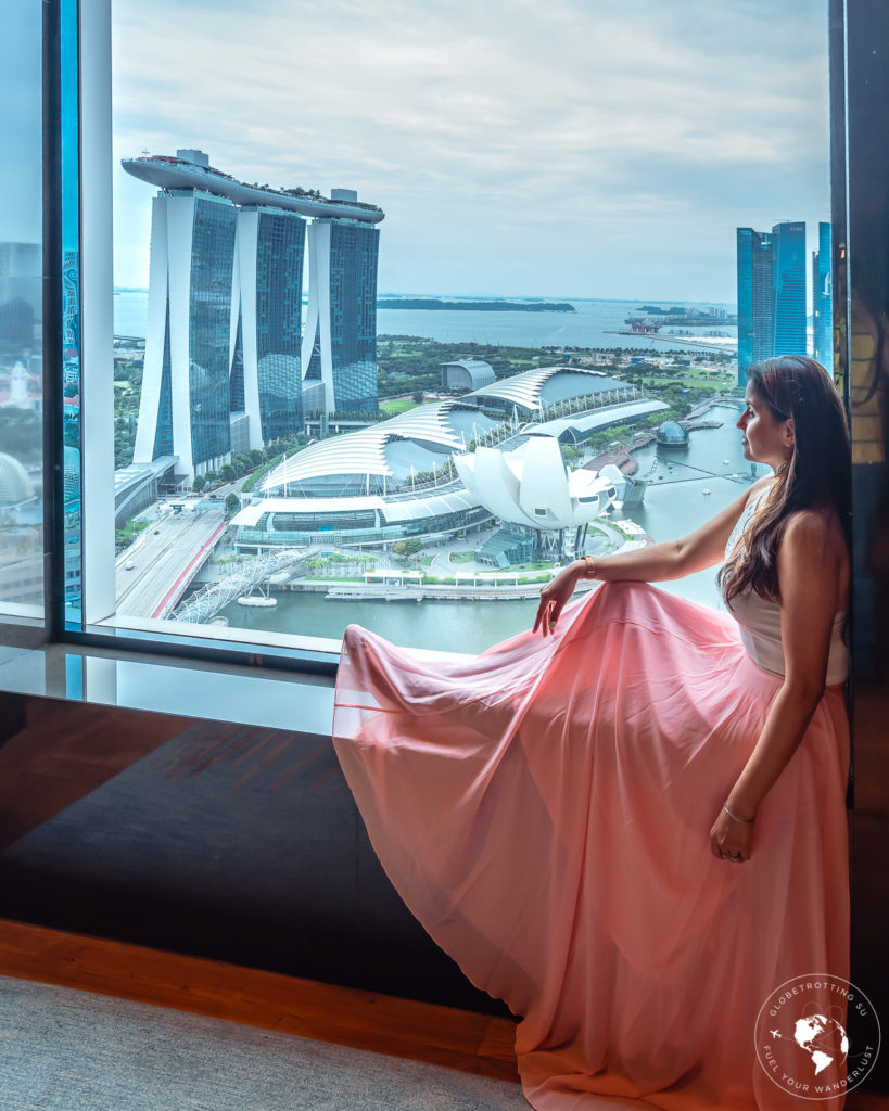Girl enjoying the magnificent views of Singapore skyline from Ritz Carlton Millenia